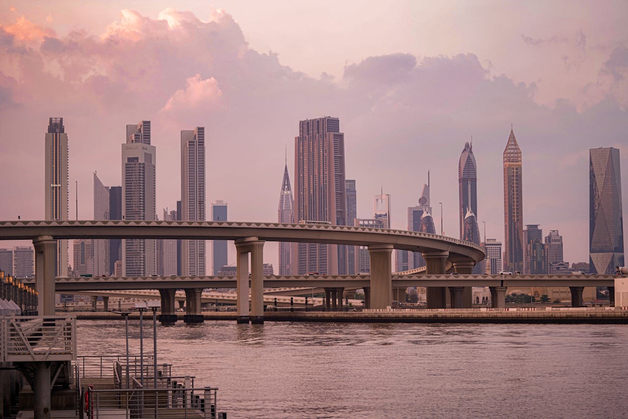 Captivating view of Dubai's skyline featuring modern skyscrapers and bridges at sunset.